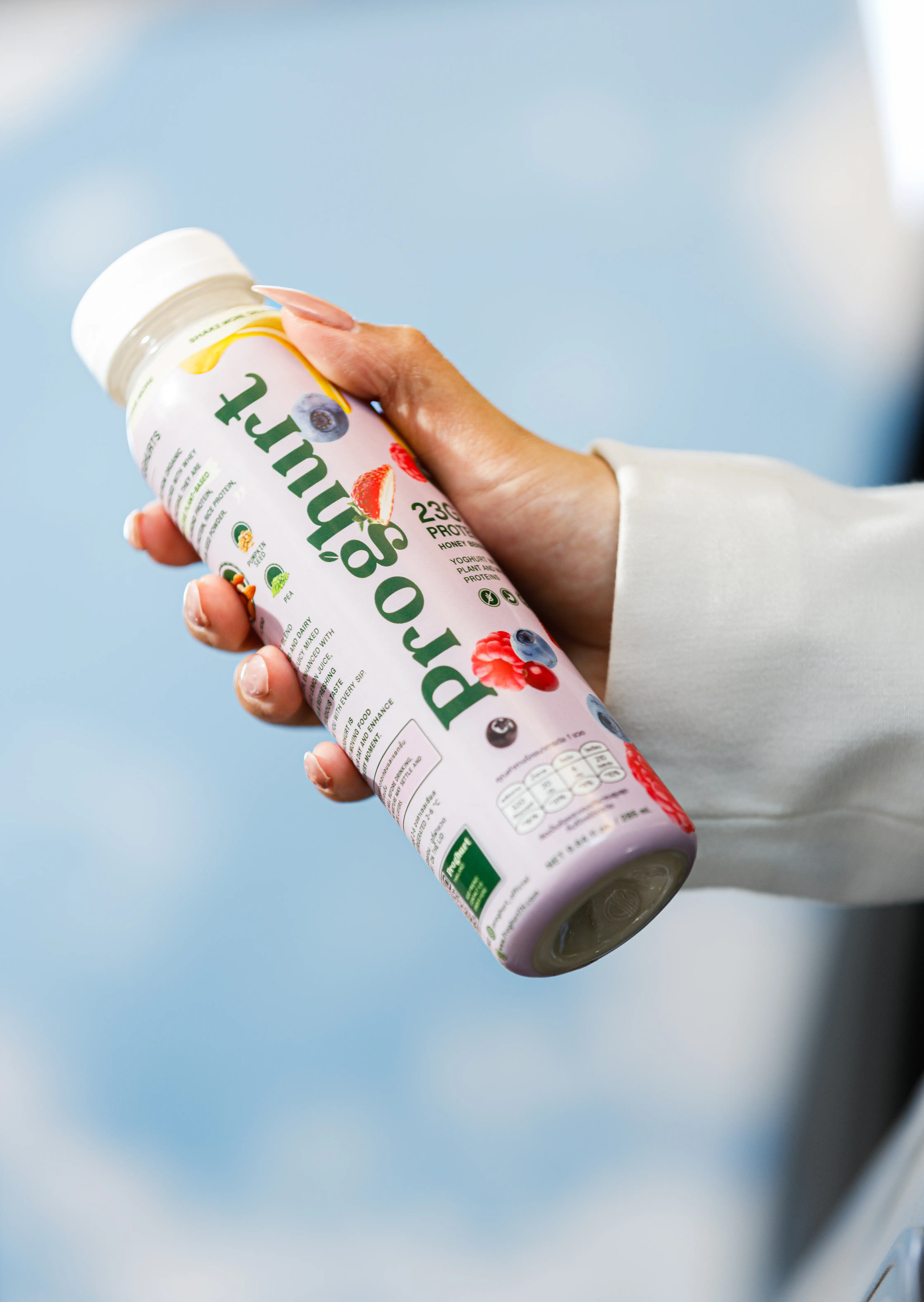 Hand holding Honey Berries bottle