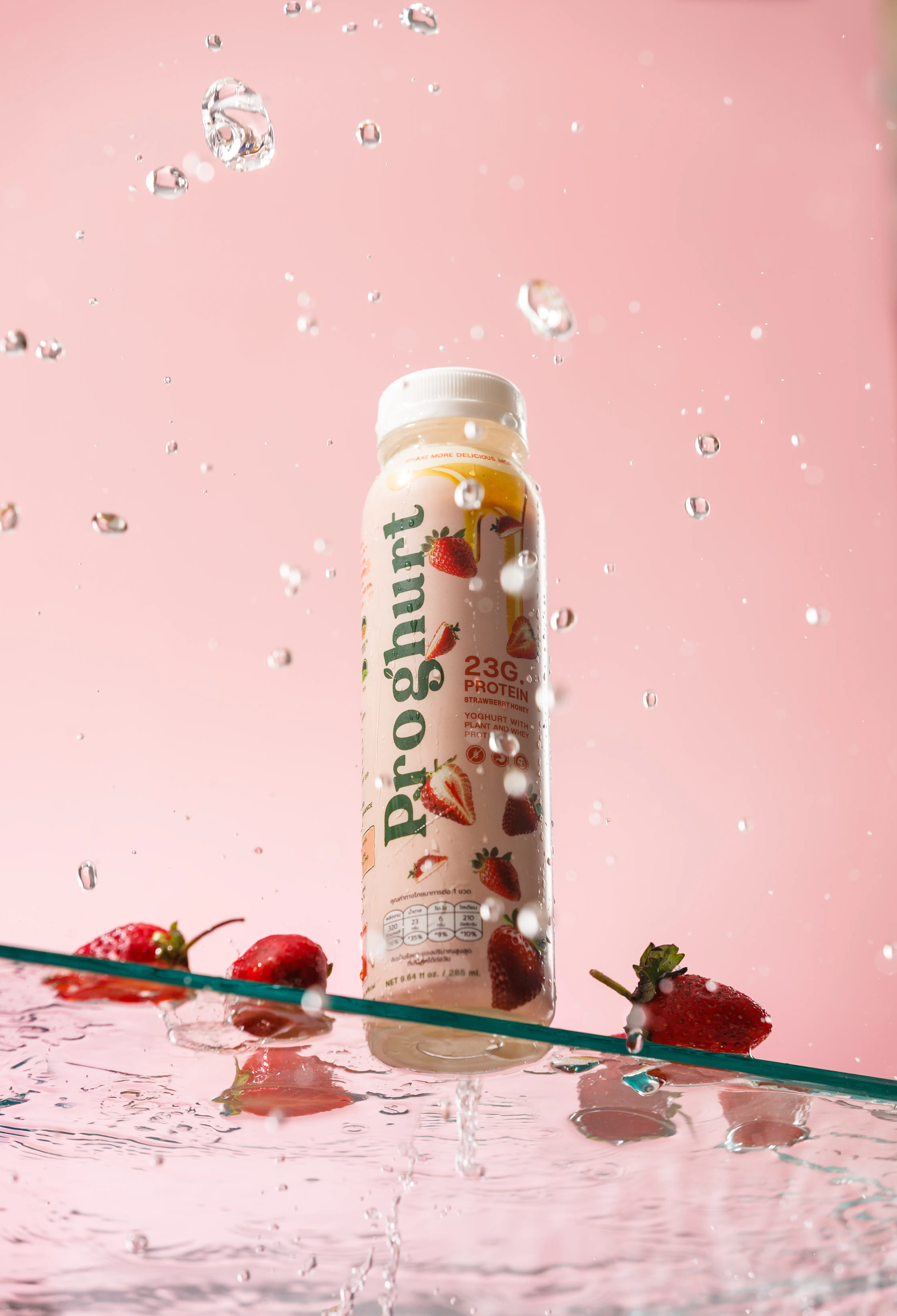 Strawberry Honey over glass with strawberry pieces beside it